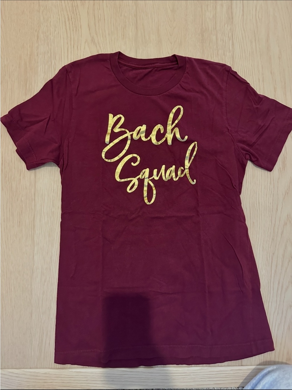 Bach Squad Women's Short-Sleeve Tee in Burgundy with Gold Script